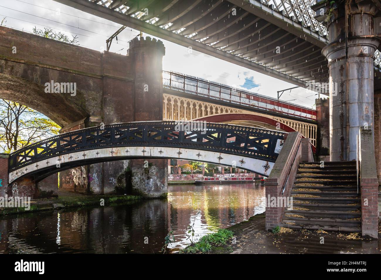 Castlefield Bridgewater canal with new and old railway viaducts and bridges using old (cast iron and brick) and modern steel architecture. Deansgate, Stock Photo