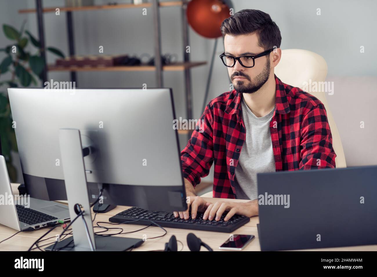 Portrait of attractive experienced focused guy writing creating code security database development at office work place station indoor Stock Photo