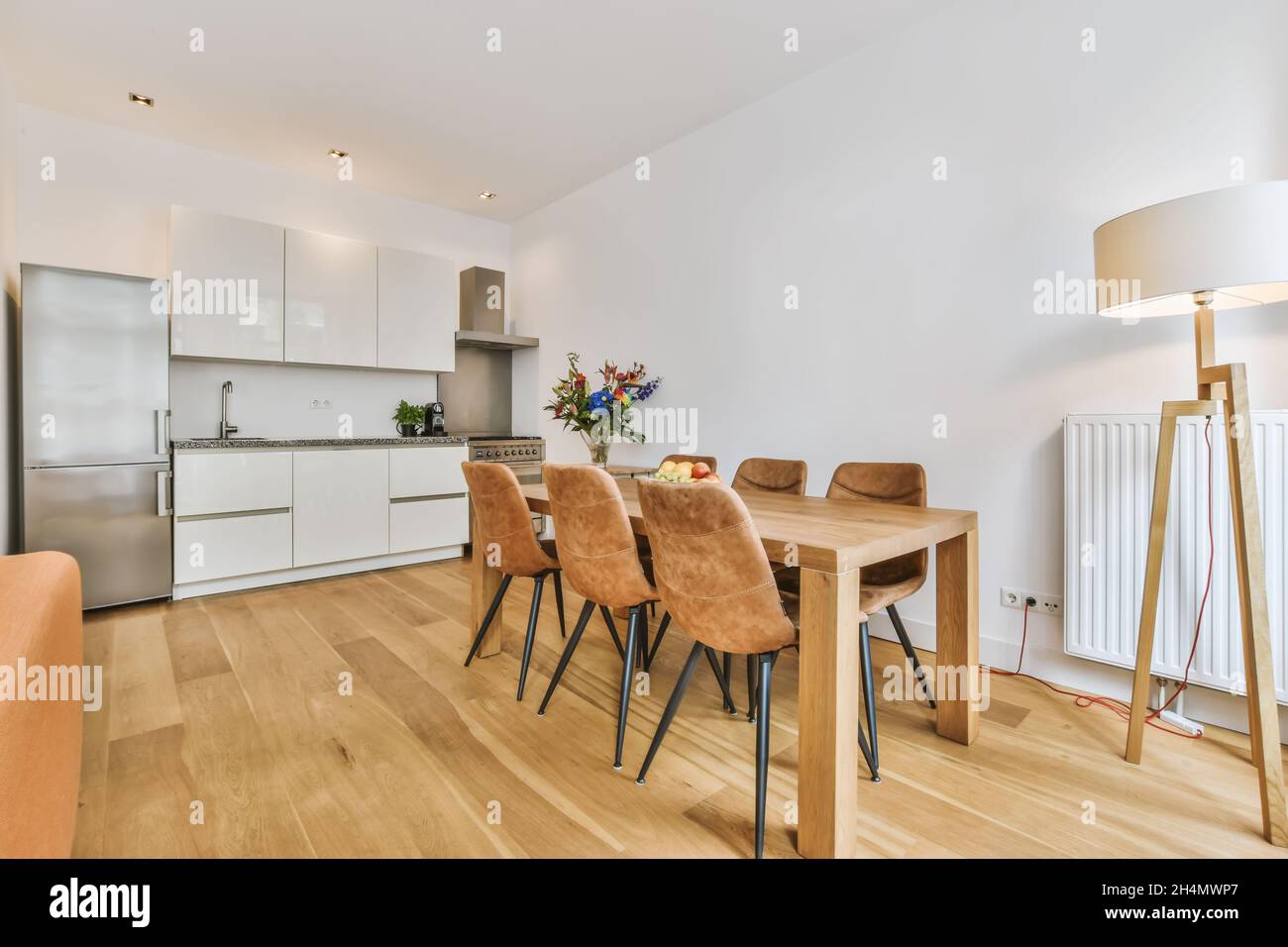 Beautiful image of the living room and kitchen area in a white interior ...