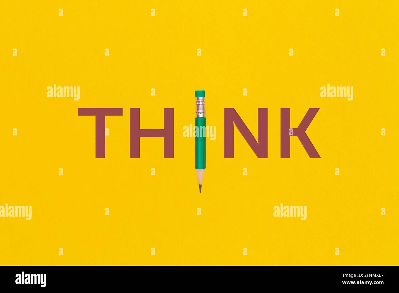 The word 'Think' on yellow background. Top view or flat lay. Stock Photo