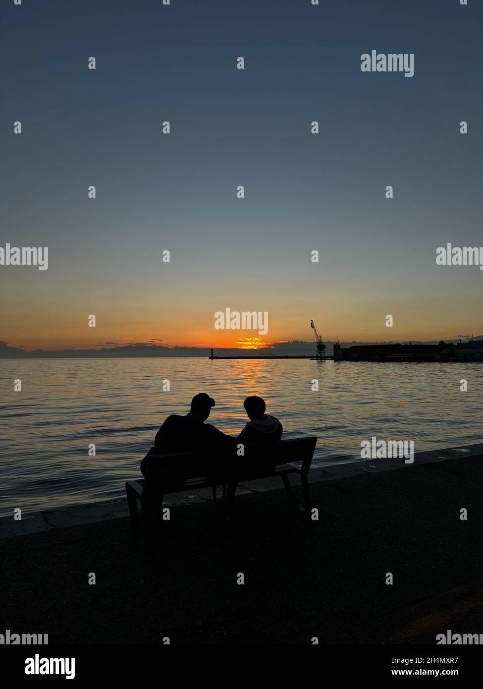 Silhouette of Senior couple enjoying the Sunset by the sea Stock Photo ...