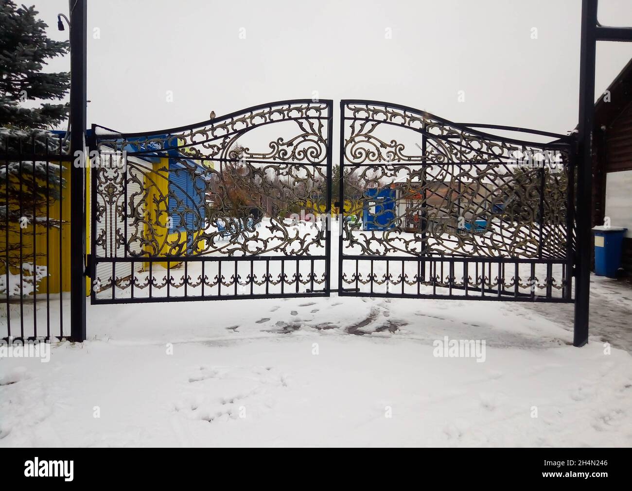 Beautiful wrought iron gates on a snowy winter day. Stock Photo