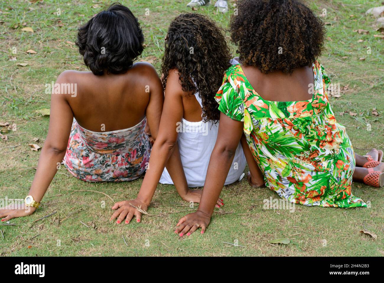 Three black woman posing for photo. They have their backs to the camera. Salvador, Bahia, Brazil. Stock Photo