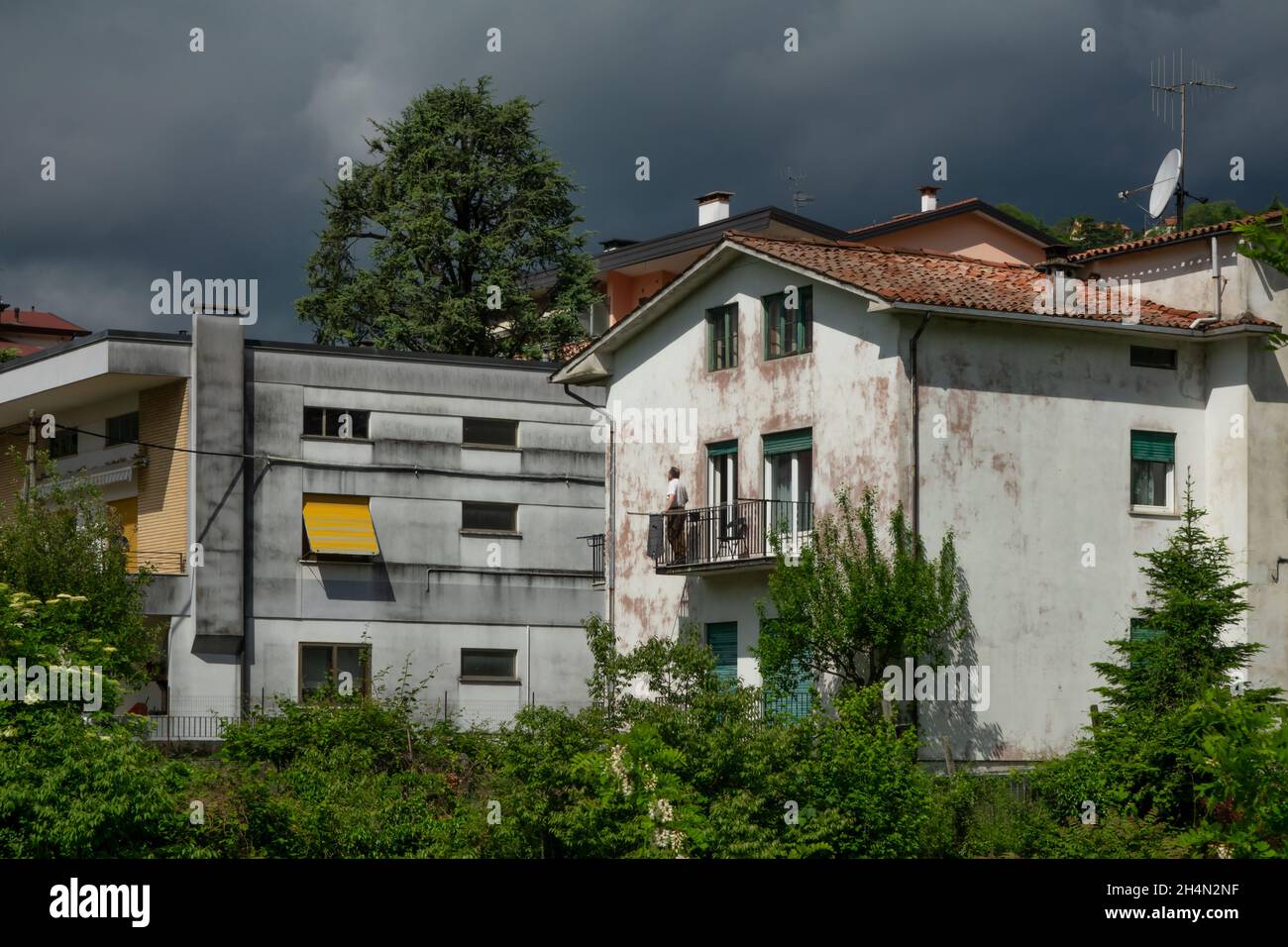 14 may 2021, Valdagno, Italy: man watching the storm coming from the balcony of the house Stock Photo