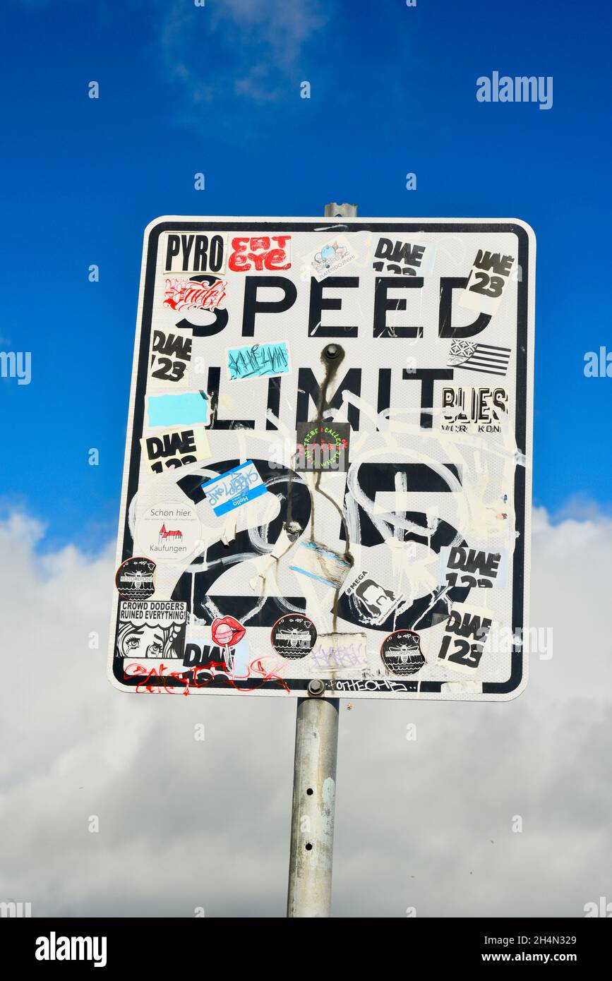 Graffiti, bumper stickers and other stickers covering Speed Limit
