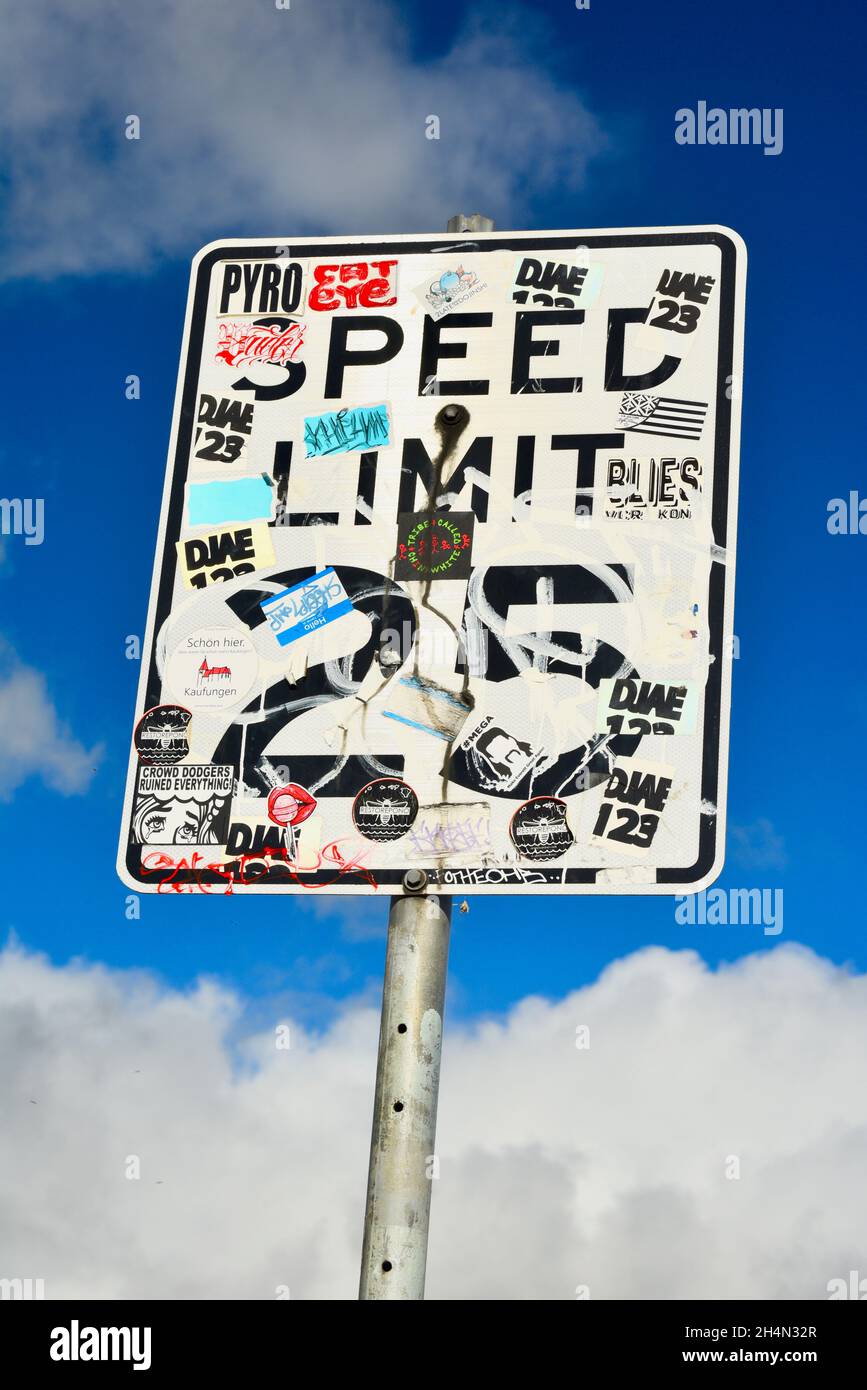 Graffiti, bumper stickers and other stickers covering Speed Limit