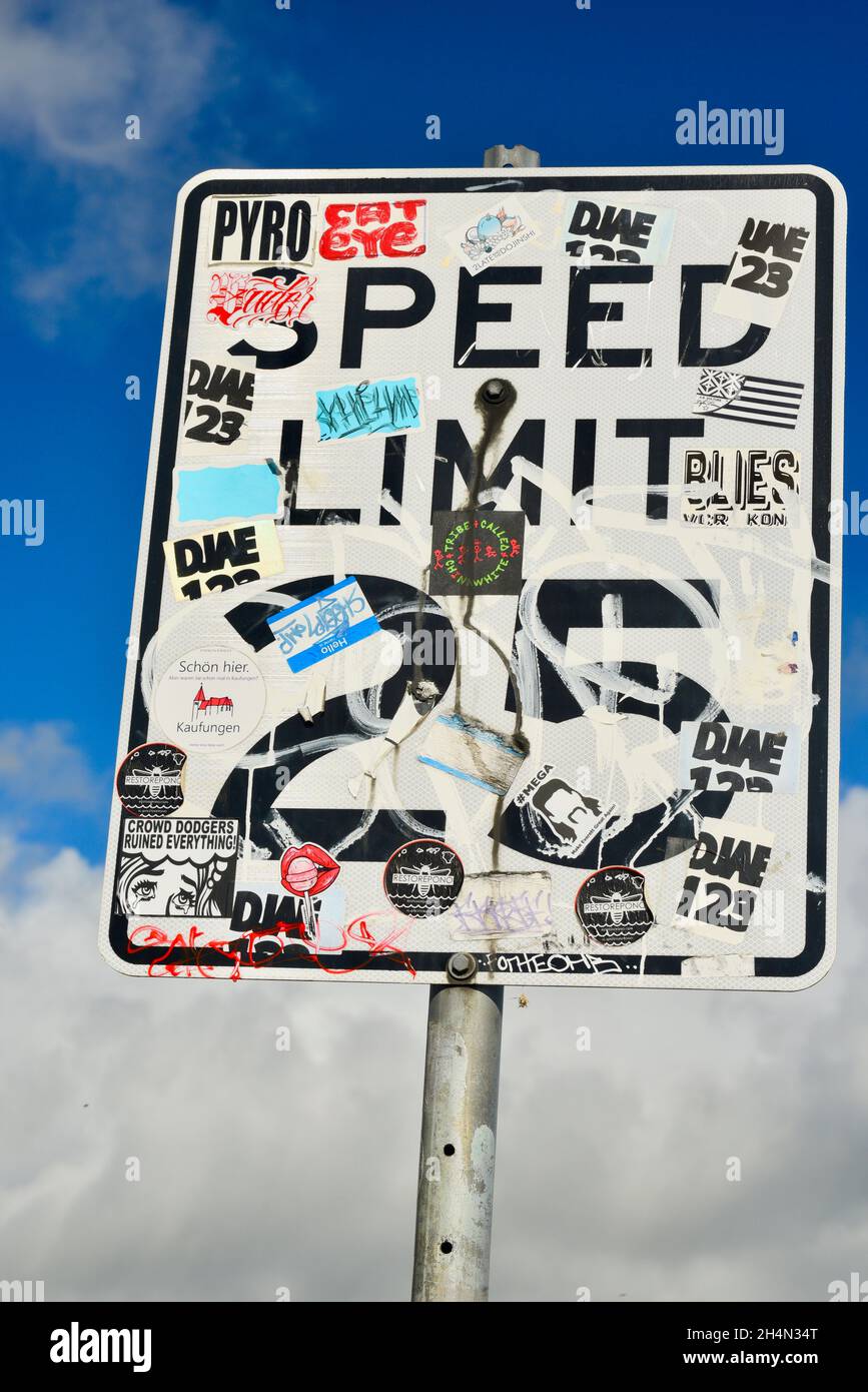 Graffiti, bumper stickers and other stickers covering Speed Limit