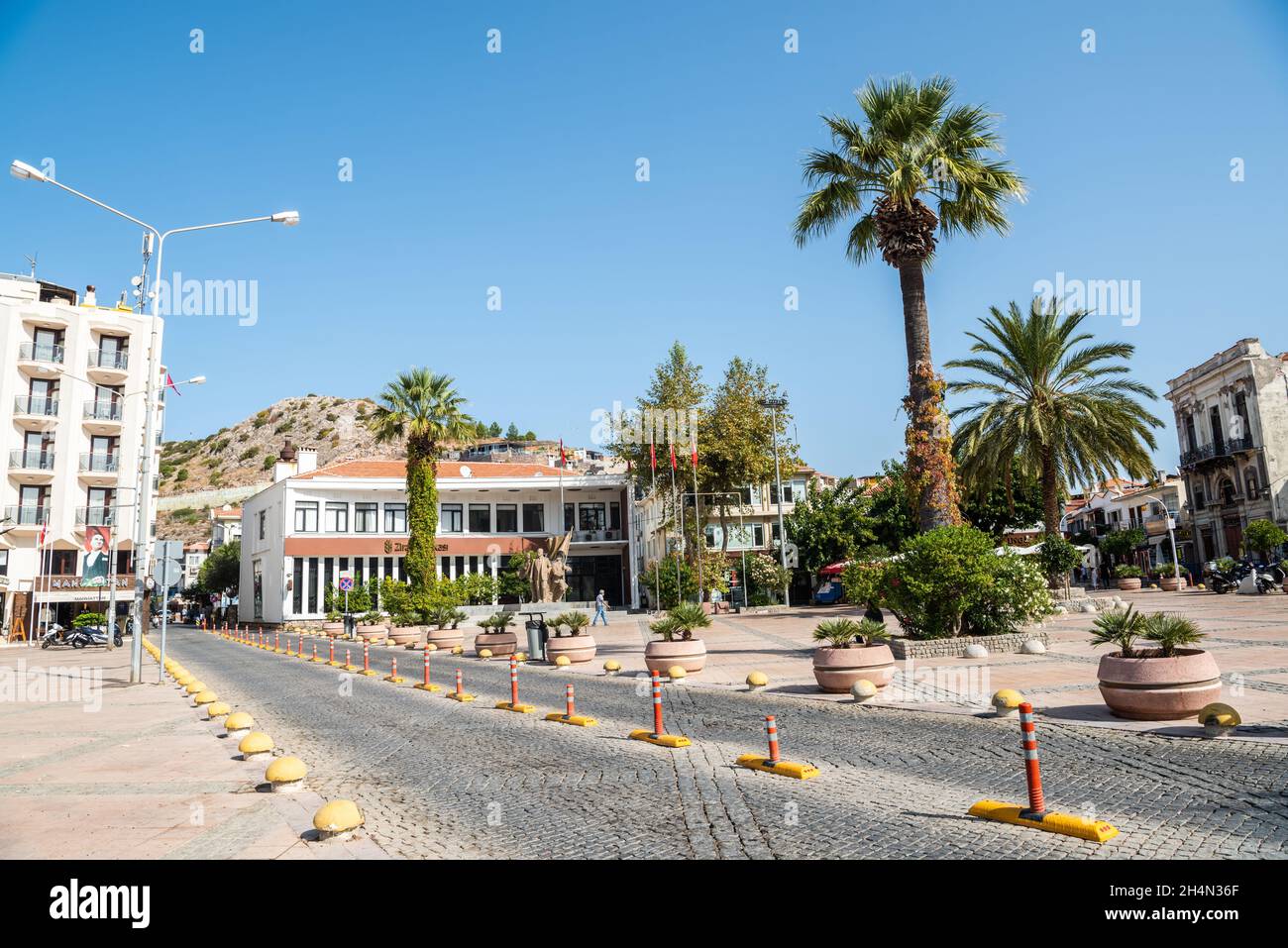 Cesme, Izmir, Turkey – October 4, 2020. View of Cumhuriyet Meydani square in Cesme resort town of Izmir province in Turkey. View with buildings, palms Stock Photo