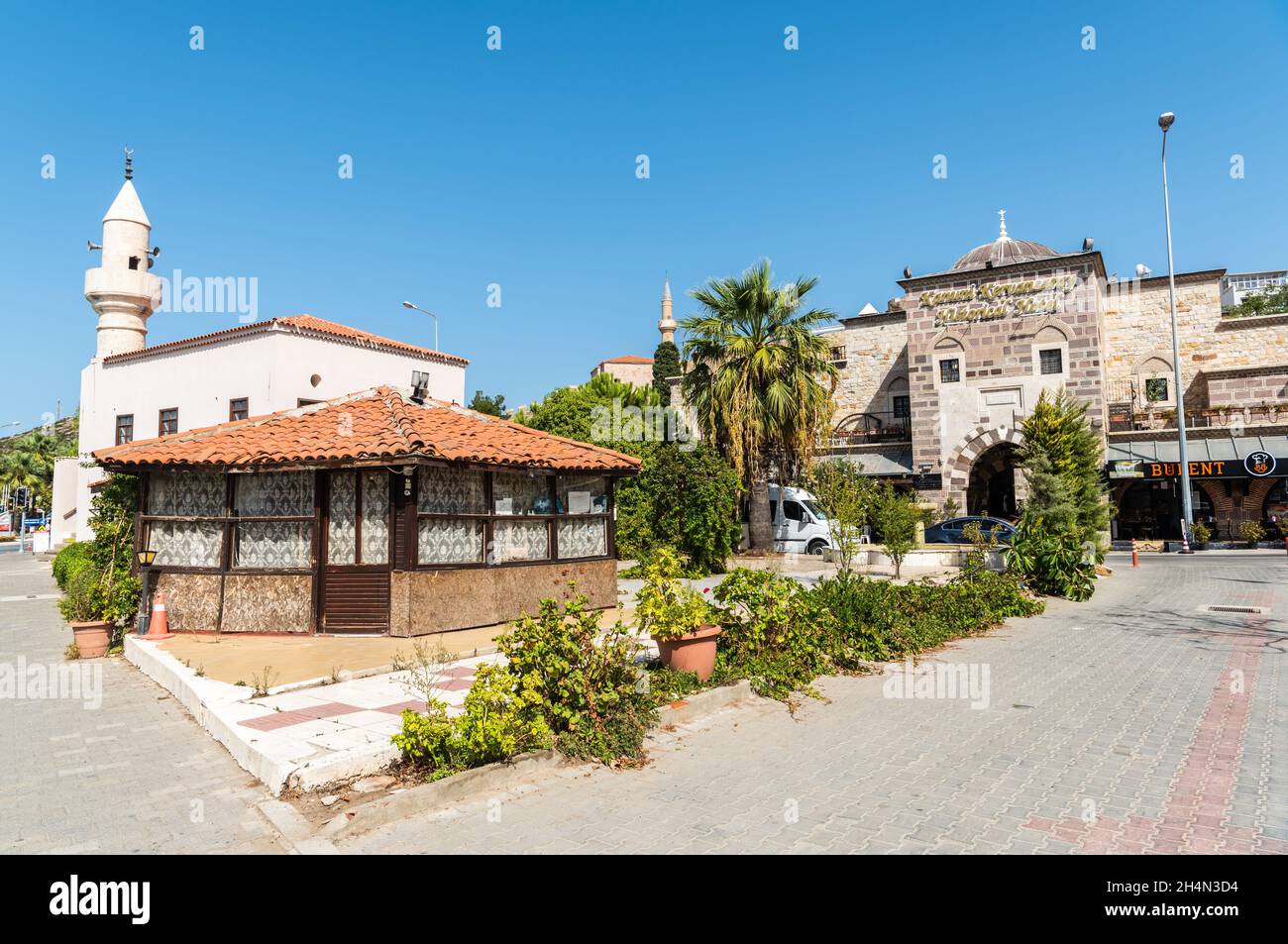Cesme, Izmir, Turkey – October 4, 2020. View of a mosque and historic Ottoman caravanserai in Cesme resort town of Izmir province in Turkey. The carav Stock Photo
