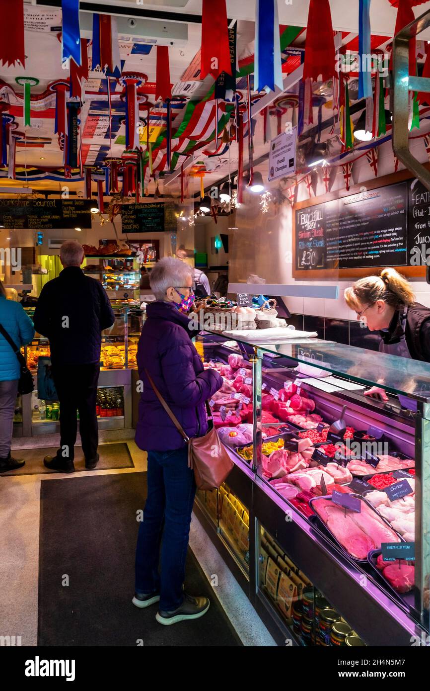 Interior of Kitson's Prize winning butchers shop in Northallerton North Yorkshire with several customers being served Stock Photo