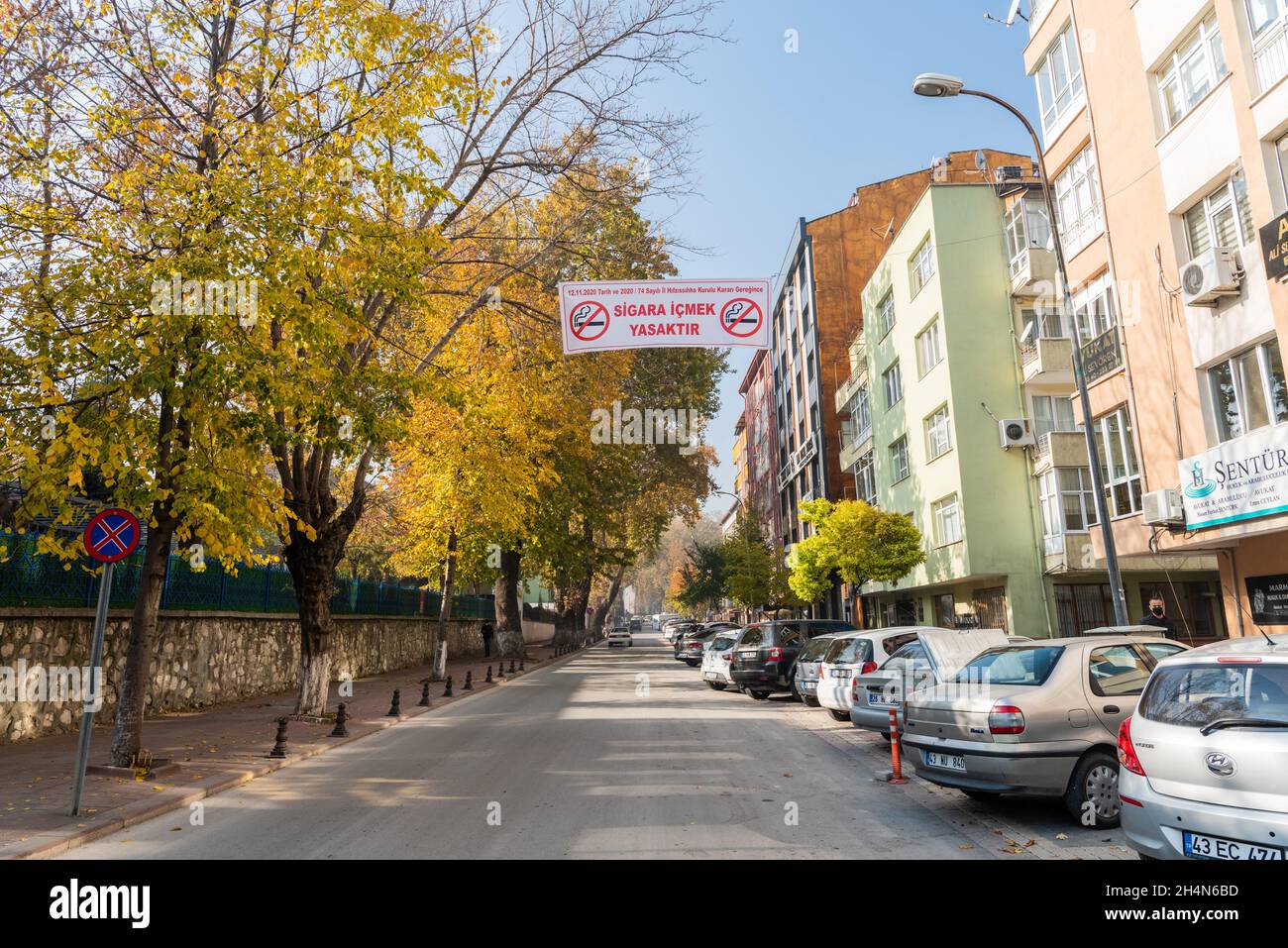 Kutahya, Turkey – November 17, 2020. Street view in Kutahya city in Turkey, with a billboard stating ‘Smoking prohibited’. Smoking in outdoor places w Stock Photo