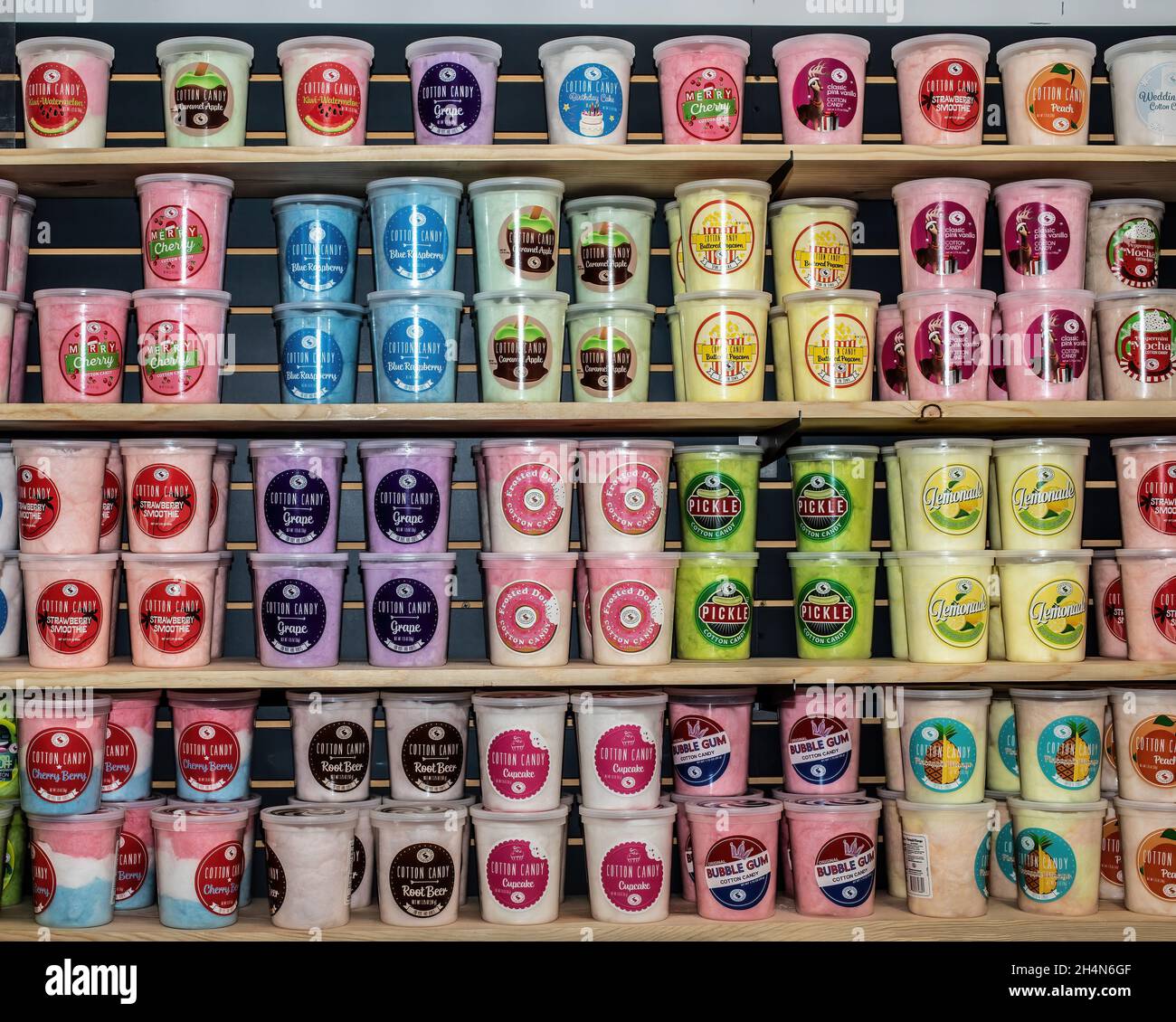 Row upon row of cotton candy of many different flavors on shelves for sale at Sweetly Kismet Candy Store in Carlton, Minnesota USA. Stock Photo