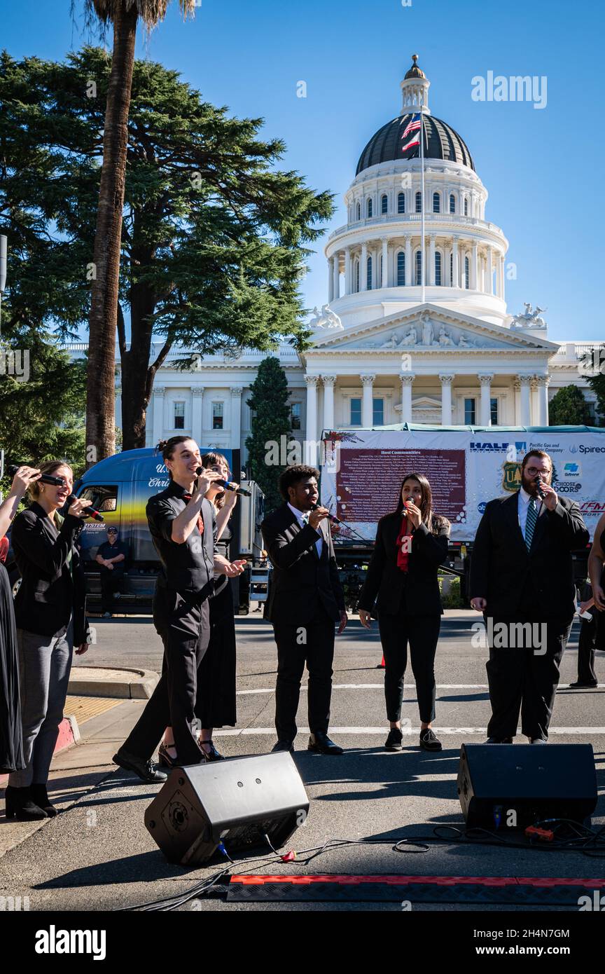 The CSUS Vocal Jazz ensemble performs 'Jingle Bells' at an event during the U.S. Capitol Christmas tree cross-country stop. Stock Photo