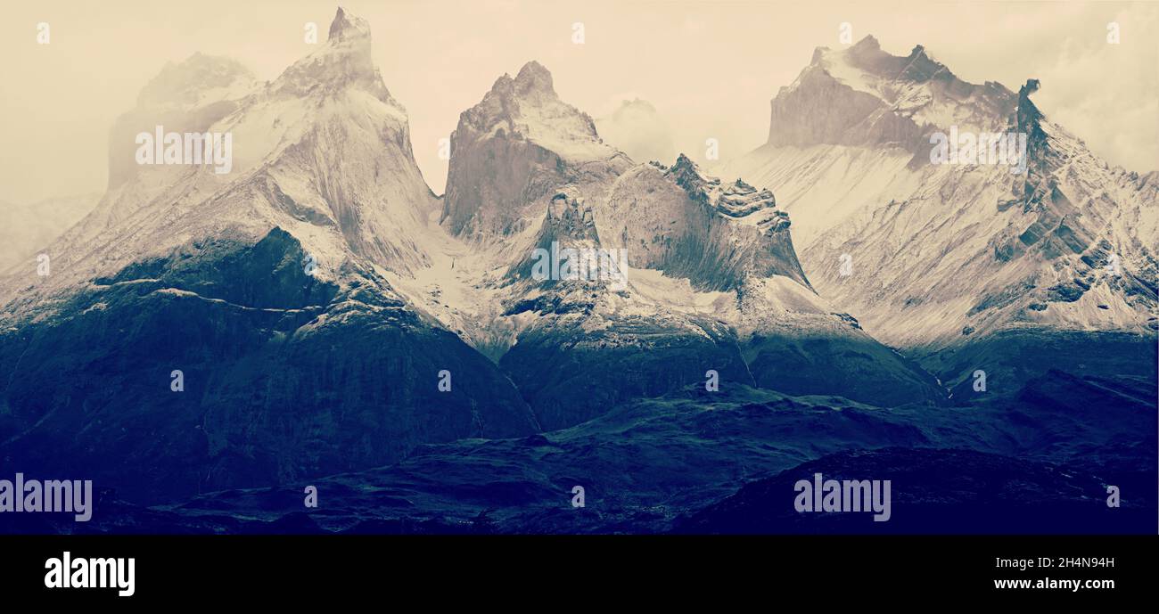Mountain peaks of Torres del Paine in Patagonia National Park Chile, peaks covered in fog. Stock Photo