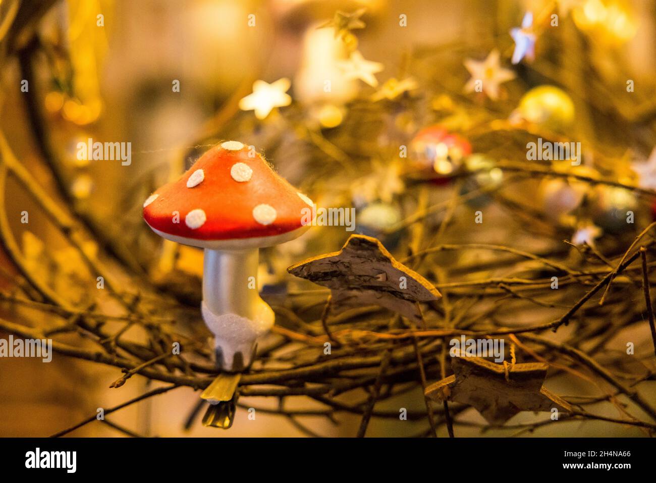 Selective focus shot of a mushroom Christmas ornament in the Belen Stock Photo