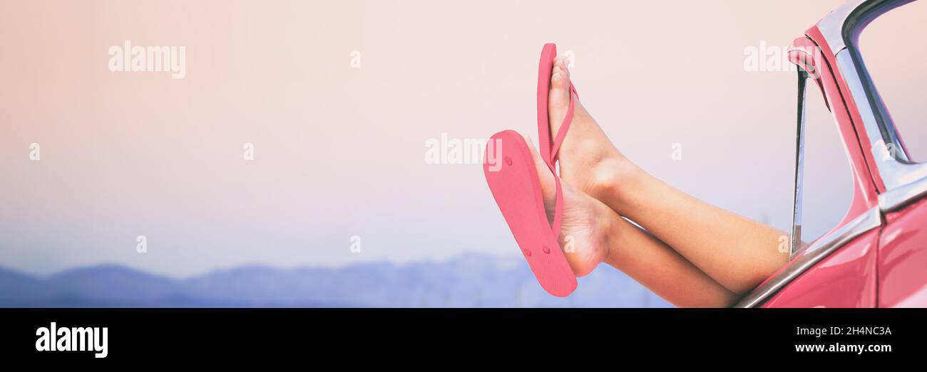 Road trip car summer fun travel vacation banner panorama. Woman's feet and legs outside window of pink vintage retro car. Freedom holiday concept Stock Photo