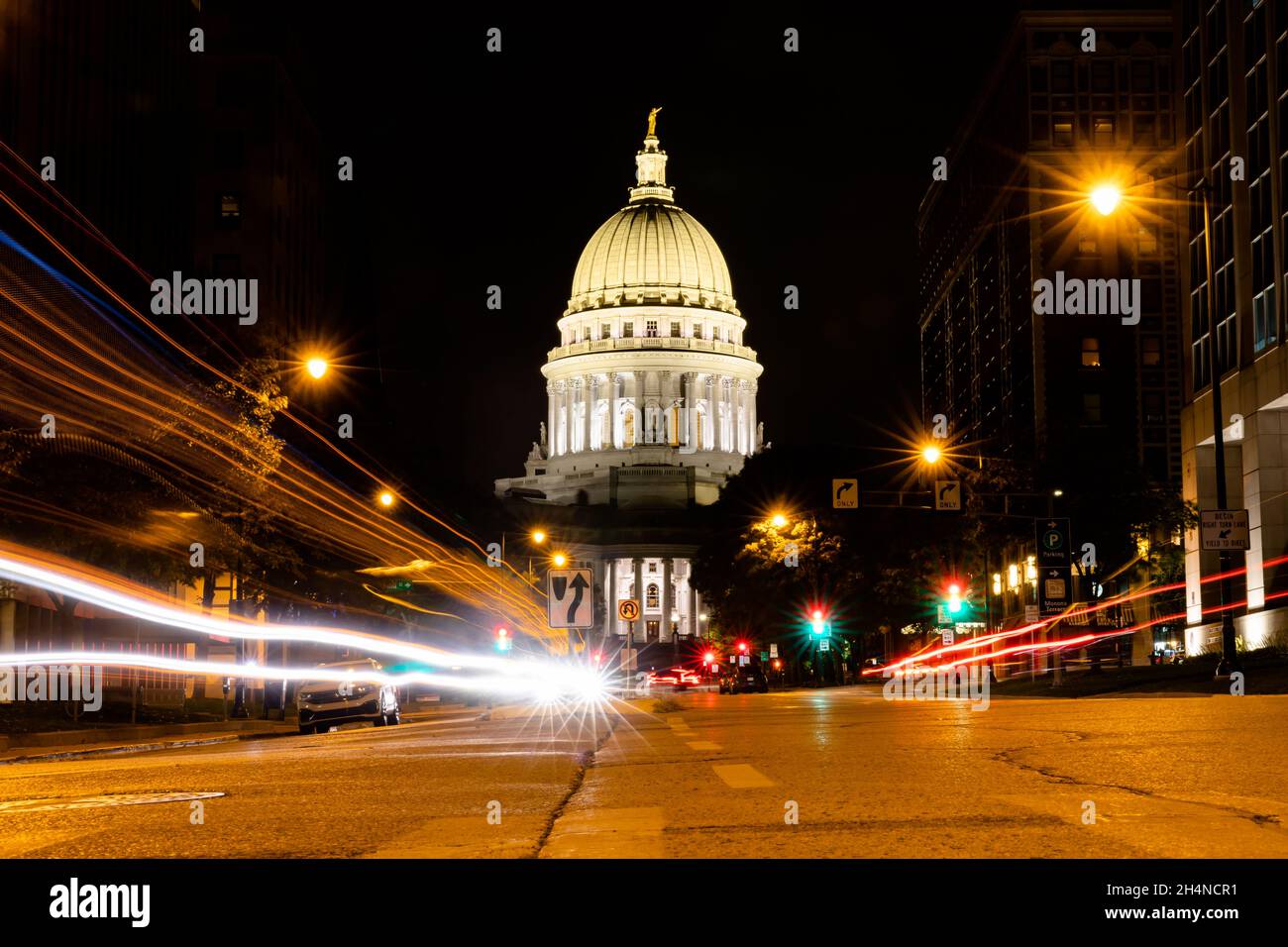 Madison, WI - October 29, 2021: Traffic goes by the Wisconsin State Capitol Building at night Stock Photo