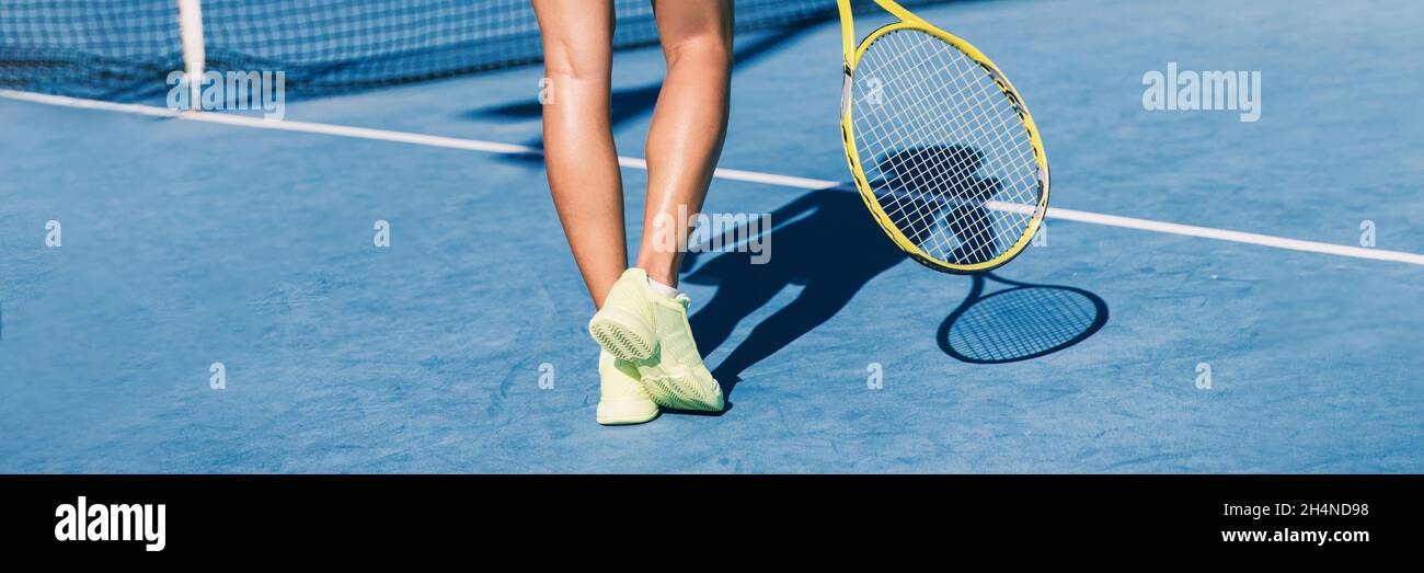 Tennis player woman shoes and racket on blue hard court background panoramic banner of athlete ready to play game. Sport exercise lifestyle. Stock Photo