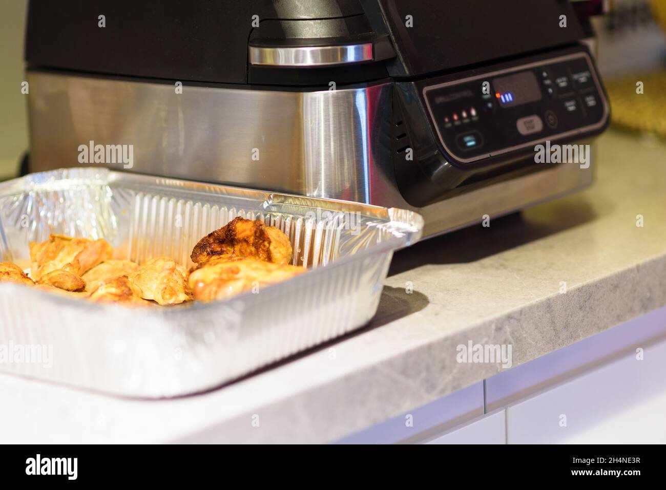 Air Fryer In Kitchen. Black Electric Deep Fryer Side Front View. Selective Focus. Stock Photo