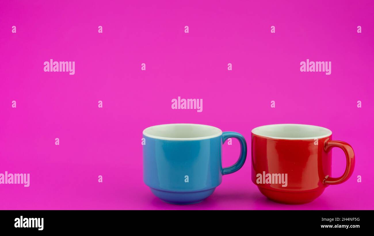 Colorful coffee cup on colorful paper background A lot of cups for coffee and tea in coffee shop