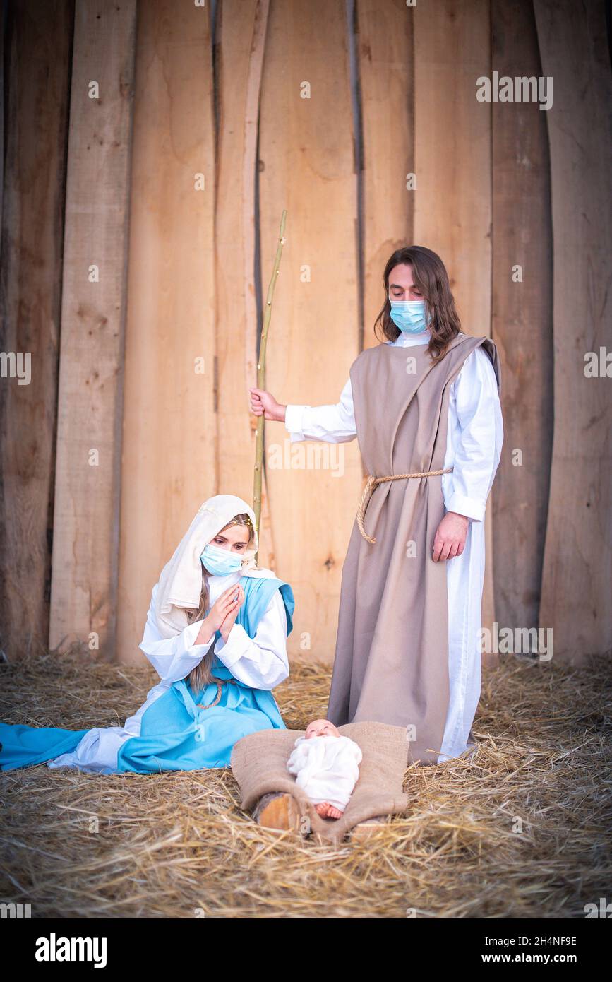 Vertical photo of nativity scene with the characters wearing masks