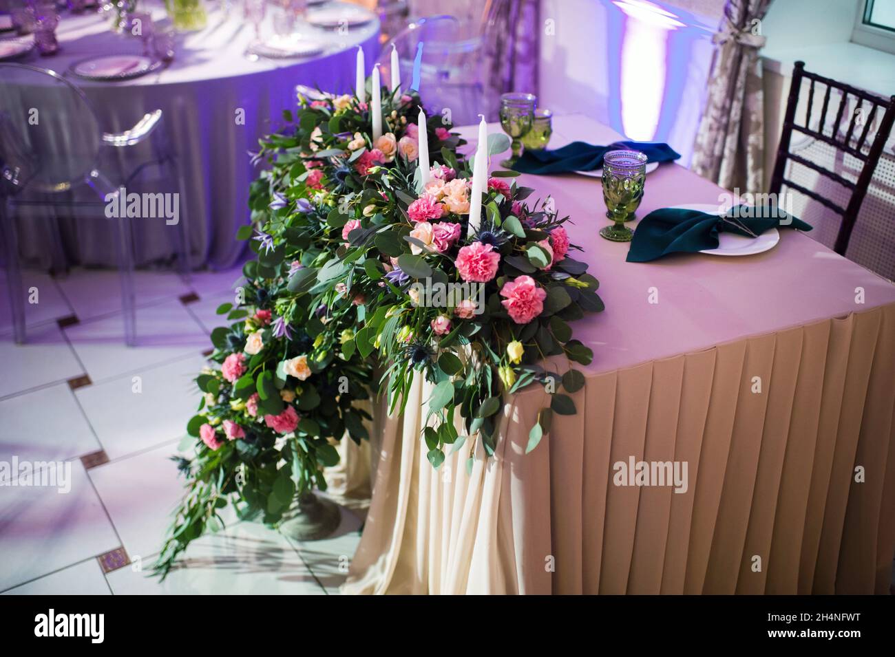 Wedding bride and groom table presidium decorated with a lot of flowers ...