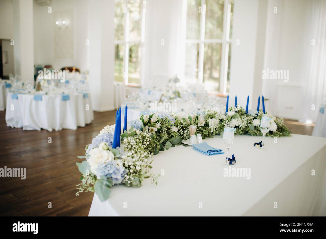 Wedding bride and groom table presidium decorated with a lot of flowers ...