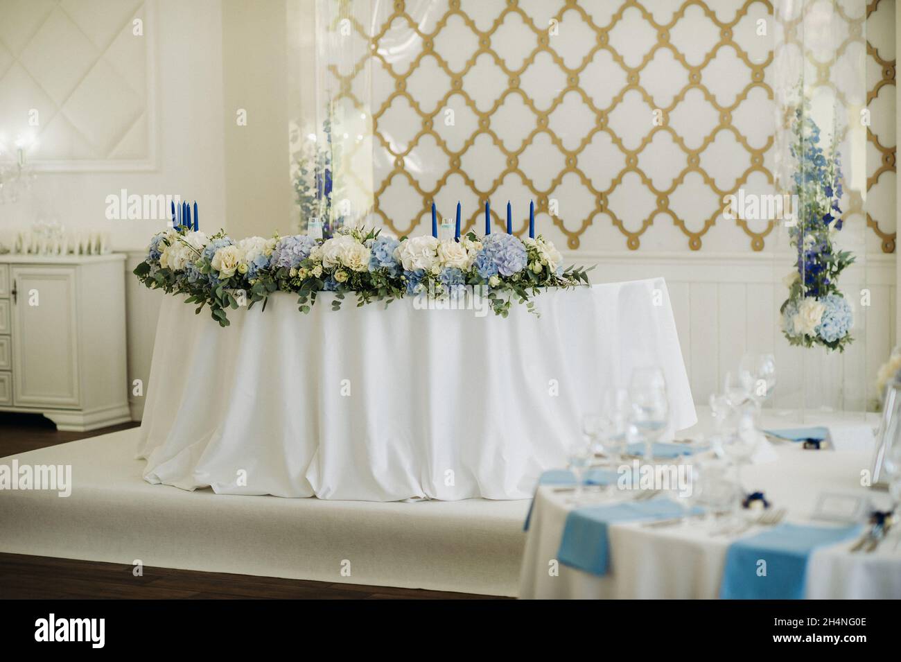 Wedding bride and groom table presidium decorated with a lot of flowers ...