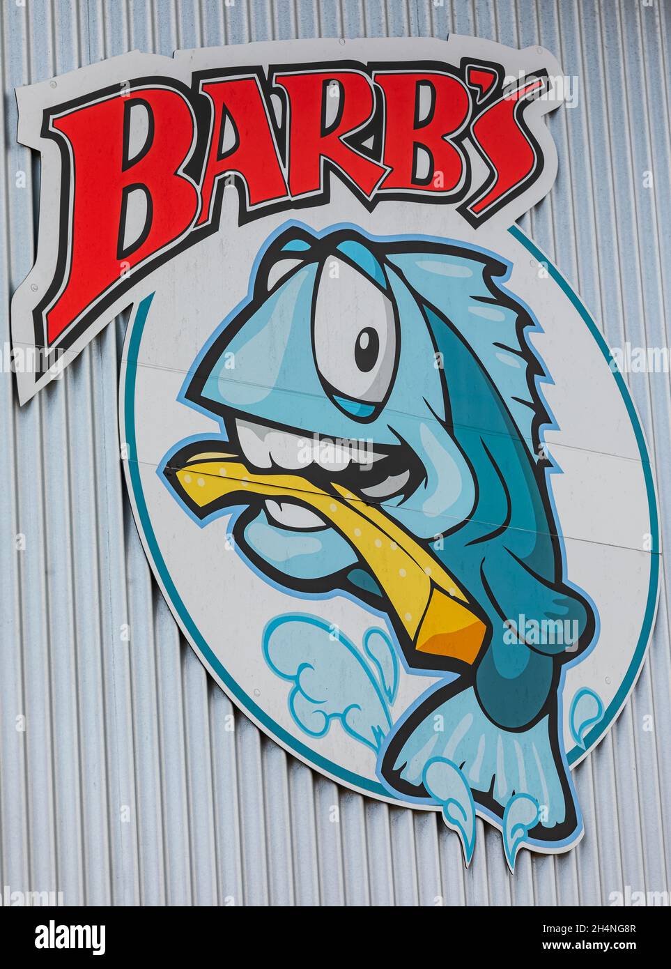 Fish and chips restaurant sign on the wall in street photo. Barb's