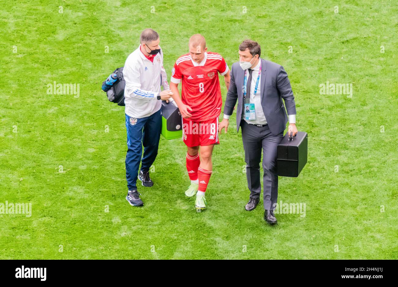 Saint Petersburg, Russia – June 16, 2021. Russia national football team doctors escorting midfielder Dmitri Barinov from the pitch following injury in Stock Photo