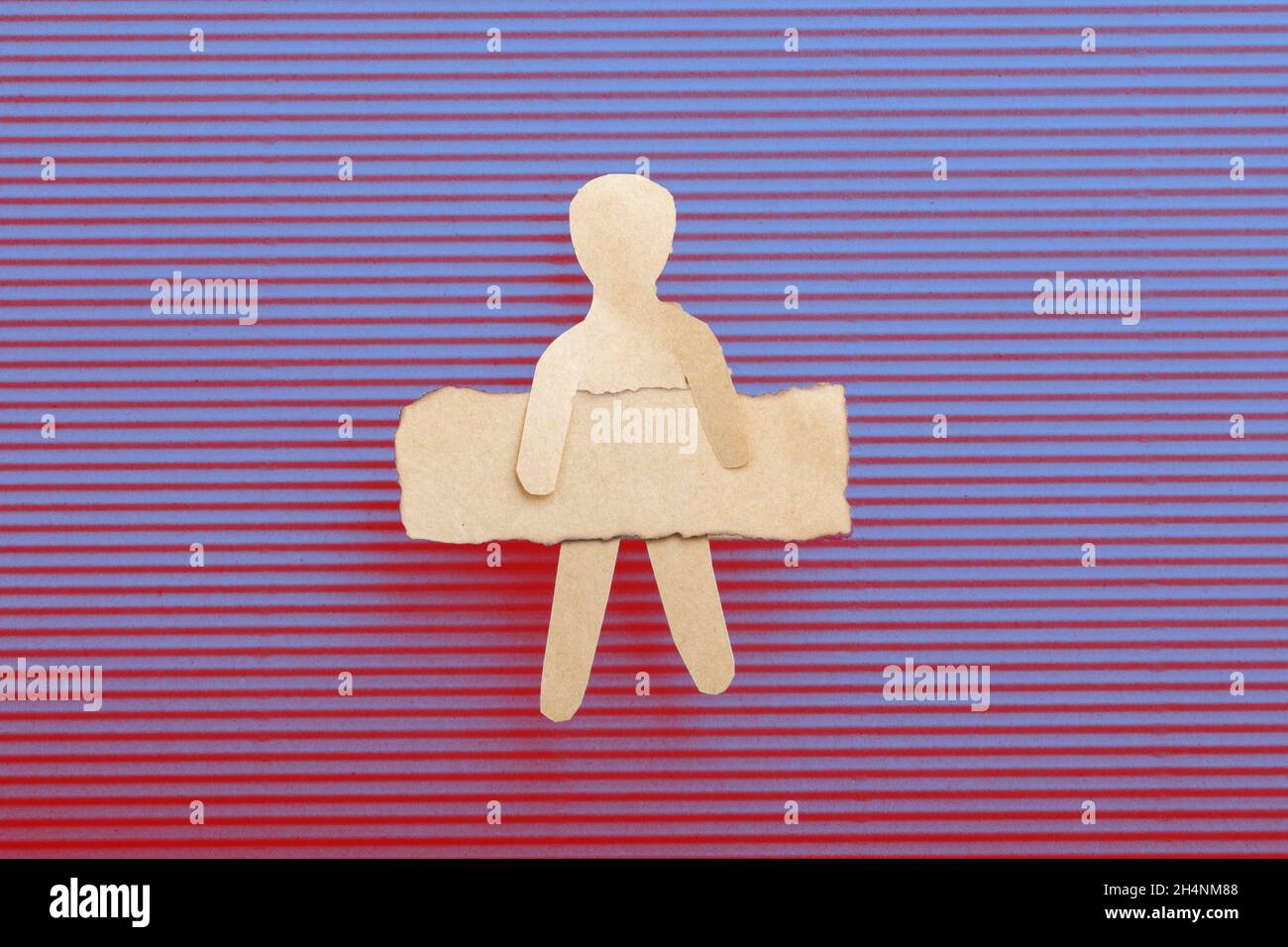 Paper man shape holding burnt note paper in hand Stock Photo