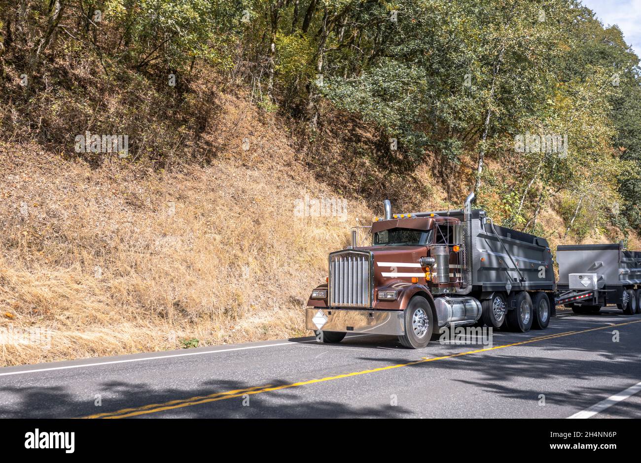 Big rig tipper semi truck with two trailers transporting commercial