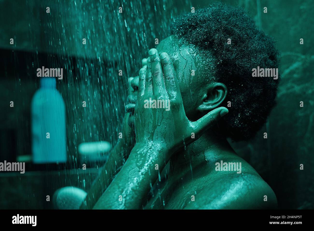 African young woman with black curly hair having a shower in the ...