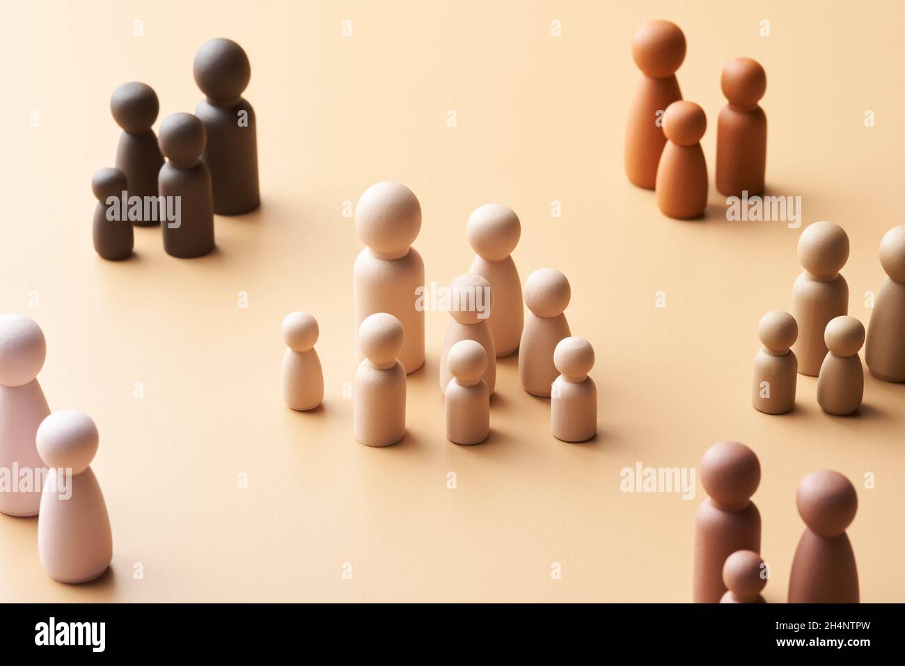 From above multi child family surrounded by multiracial parents with fewer kids against beige background Stock Photo