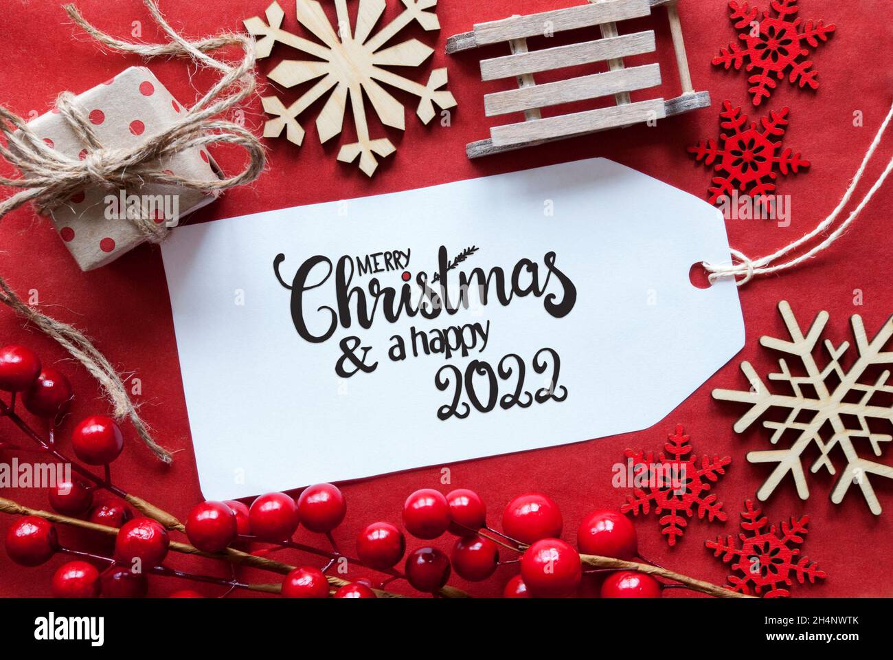 Nortwest In Christmas 2022 One Label With English Calligraphy Merry Christmas And A Happy 2022. Bright  Red Christmas Deocration Like Sled, Present And Snowlfakes Stock Photo -  Alamy
