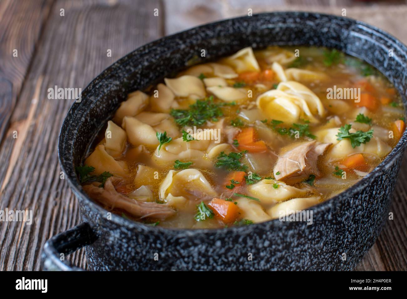 https://c8.alamy.com/comp/2H4P0ER/pot-with-chicken-noodle-soup-isolated-on-wooden-table-2H4P0ER.jpg