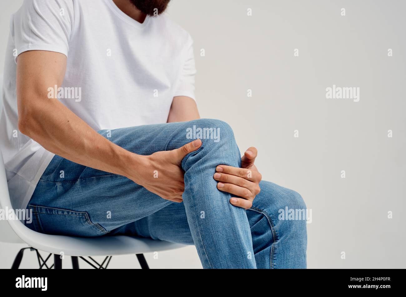 Man sitting on chair leg pain health problems medicine Stock Photo Alamy
