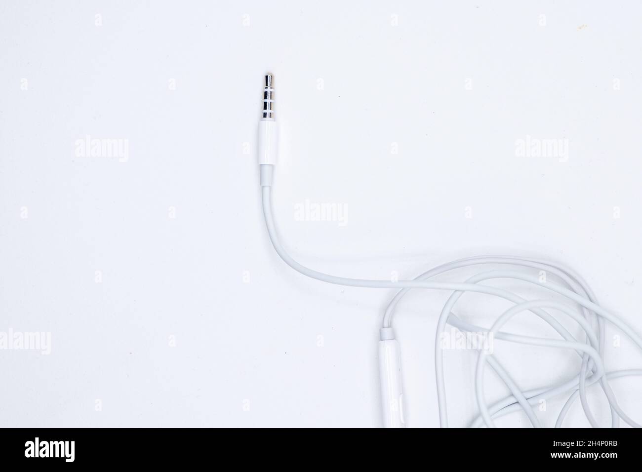 closeup of unplugged earphones minijack smartphone connector Stock