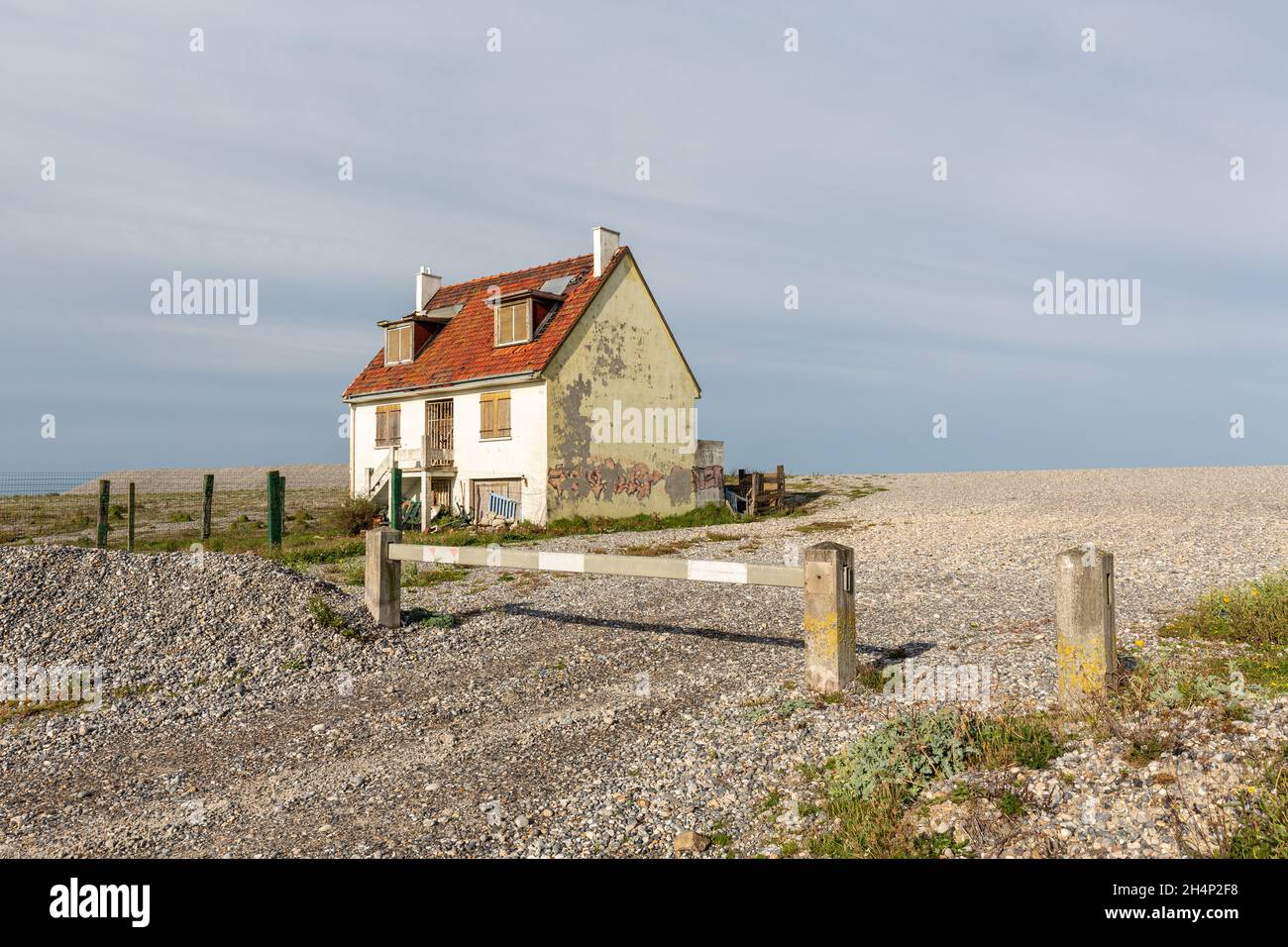 Isolated and abandoned house, built on a pebble beach in Cayeux-sur-Mer. Opal Coast, France Stock Photo