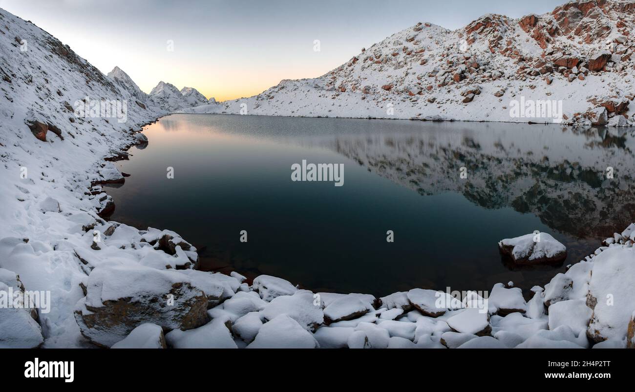 A high-mountain lake with mountain peaks covered with snow in the Karachay-Cherkessia Republic Stock Photo