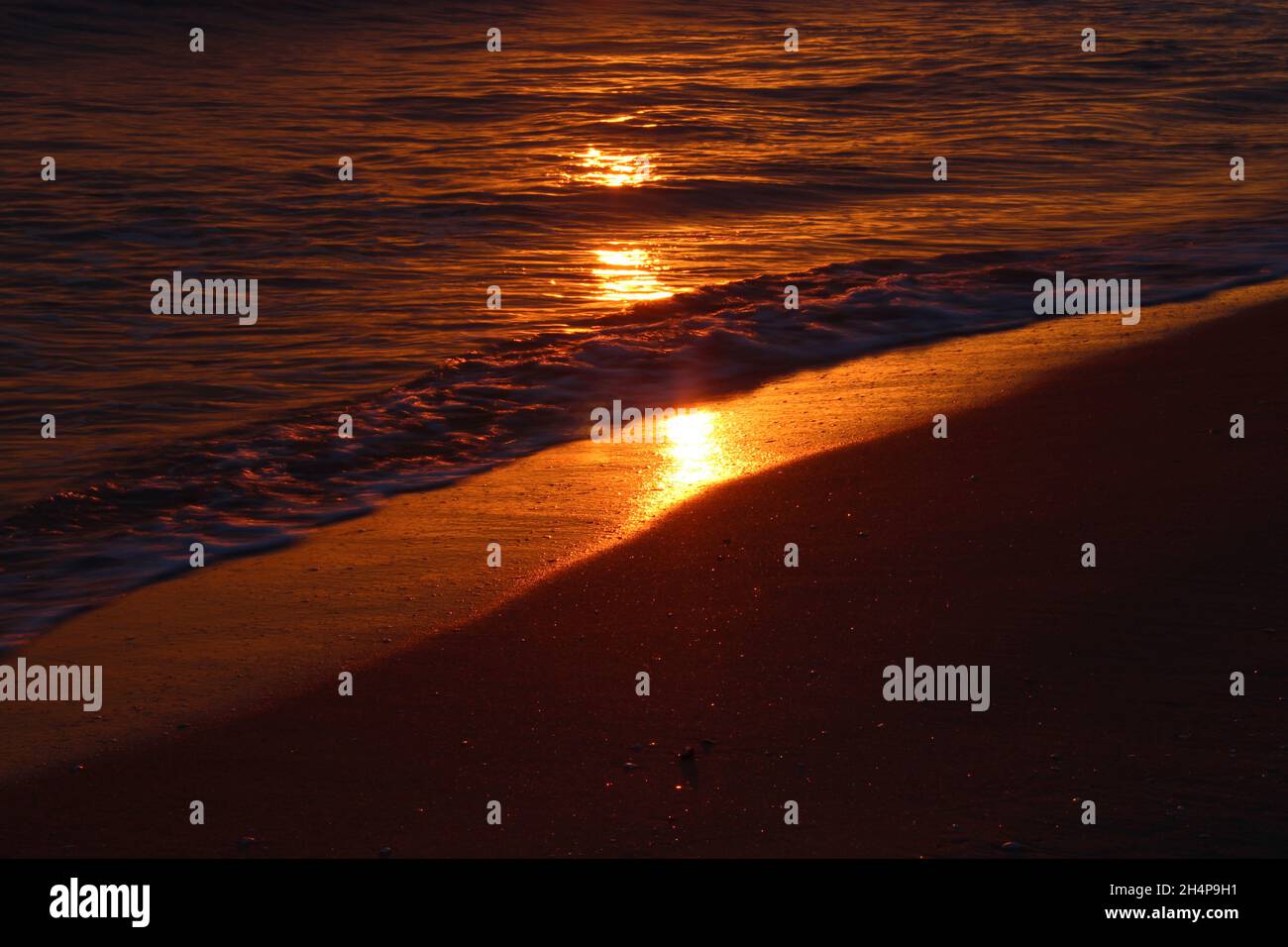 Exotic Sunrise shore with sunlight on waves, Mediterranean Sea Stock Photo