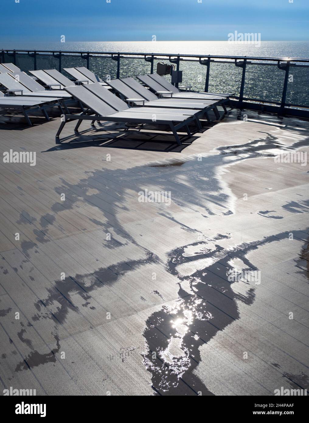 On deck, after rain. One of the oddities of the ongoing pandemic is ocean liners filled with passengers, desperate to get away from it all, sailing ar Stock Photo