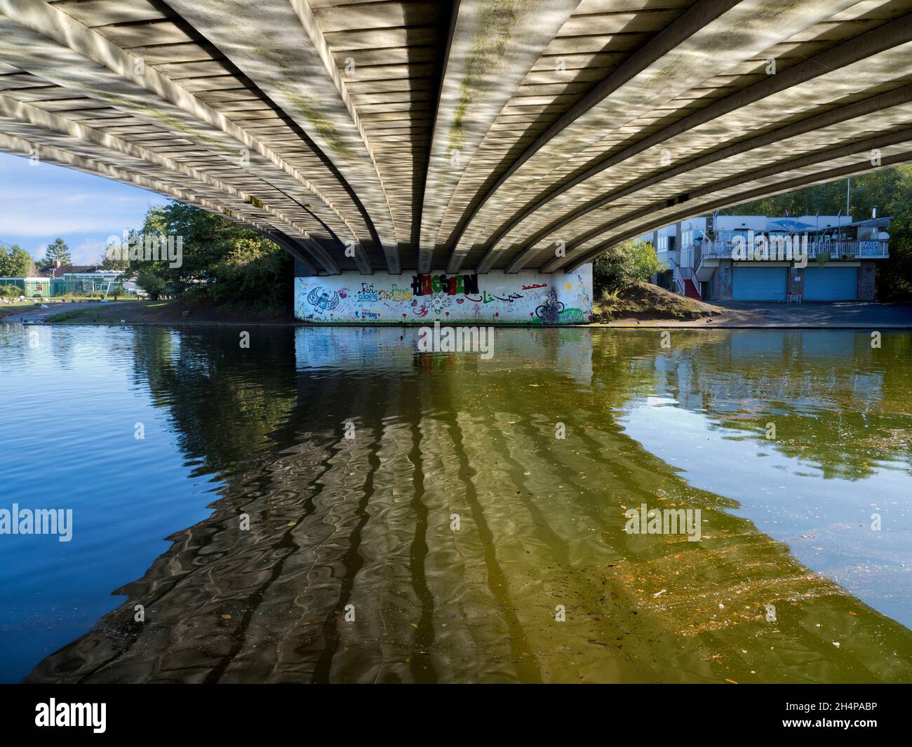 Donnington Bridge crosses the River Thames just upstream of Oxford. Here we see abstract reflections of rippled waters on its underside on a fine Autu Stock Photo