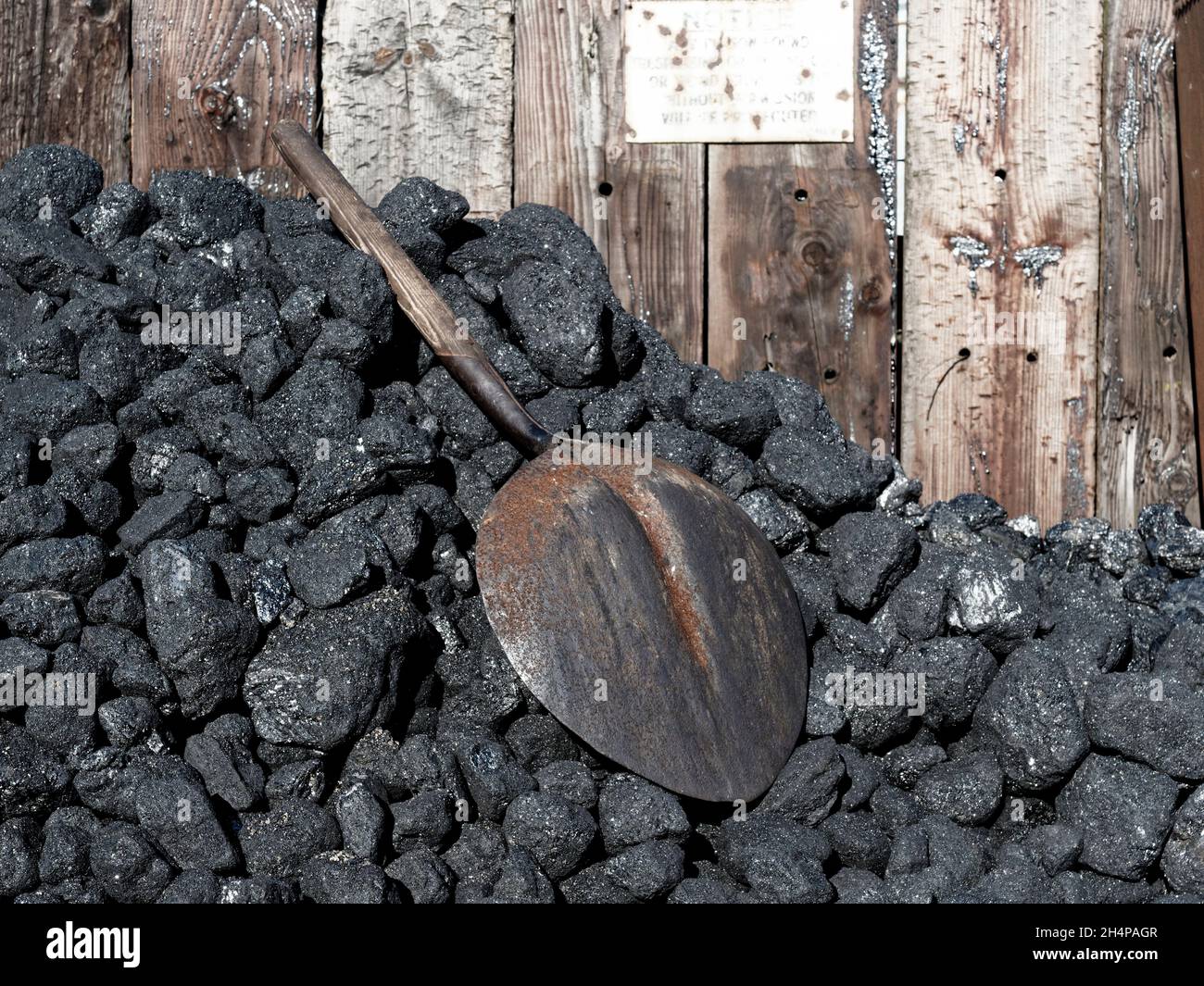 A small stack of coal for use by a steam locomotive with shovel for loading. Stock Photo