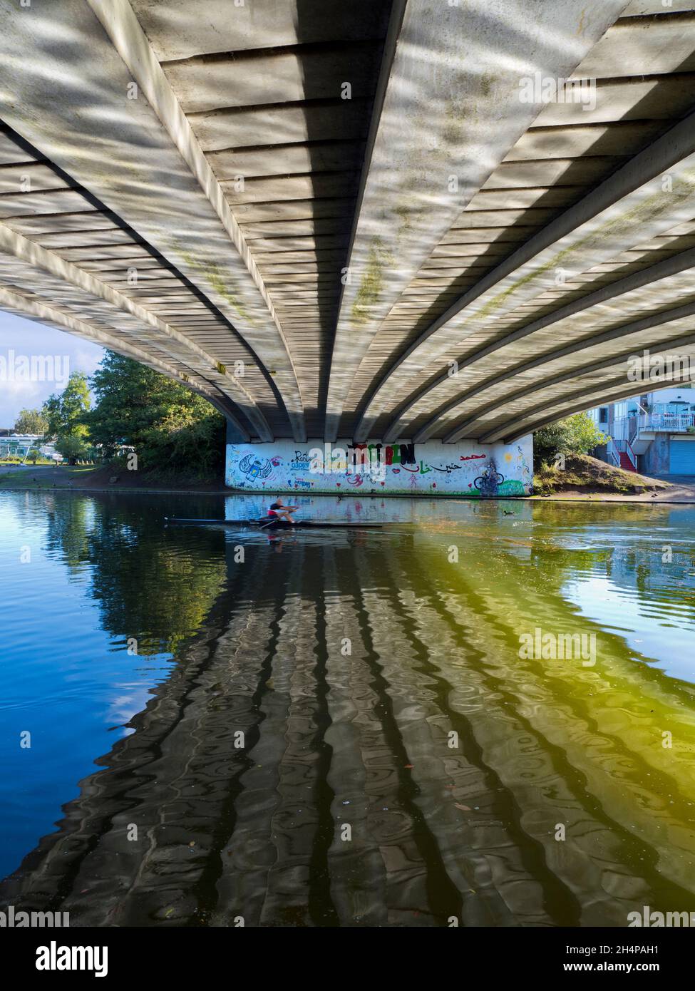 Donnington Bridge crosses the River Thames just upstream of Oxford. Here we see abstract reflections of rippled waters on its underside on a fine Autu Stock Photo