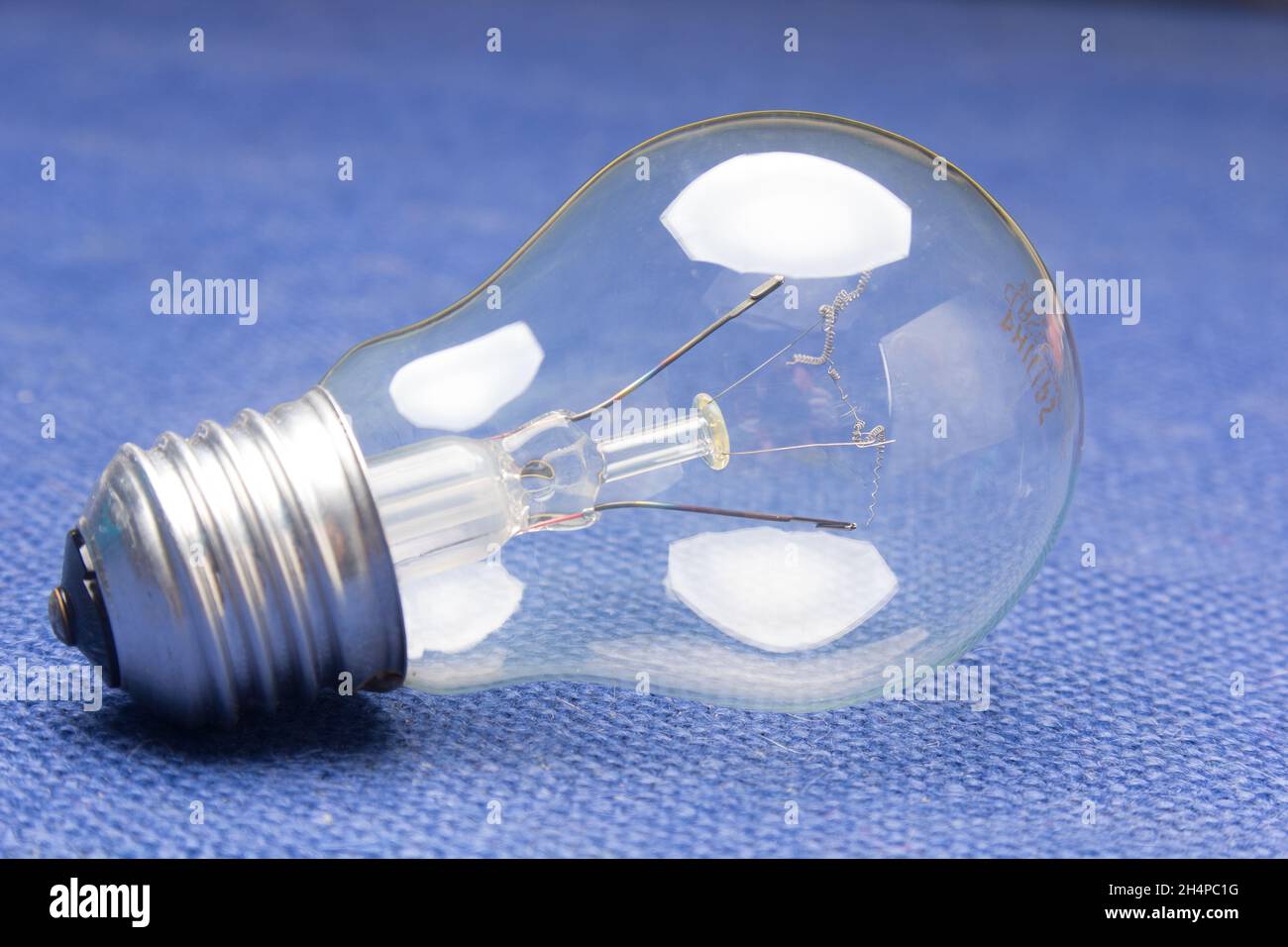 Clear glass incandescent filament bulb, analog technology Stock Photo