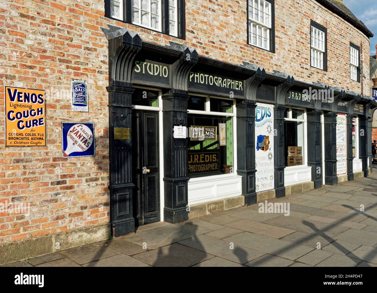 Shop buildings in the wonderful 1900's town at Beamish Museum - chemists shop with photography studio. Stock Photo