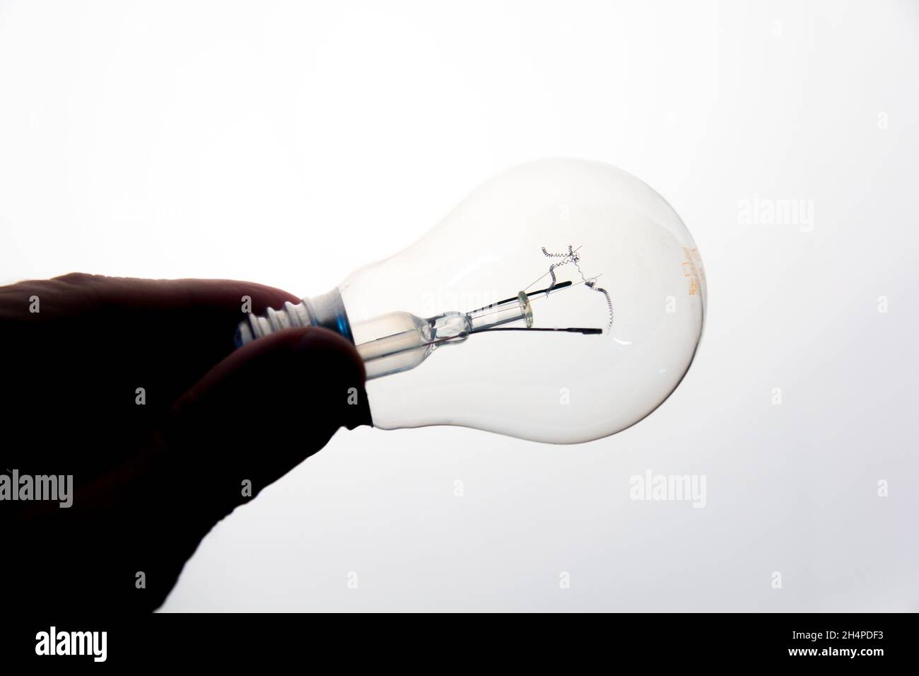 Transparent glass incandescent bulb generates light and a lot of heat