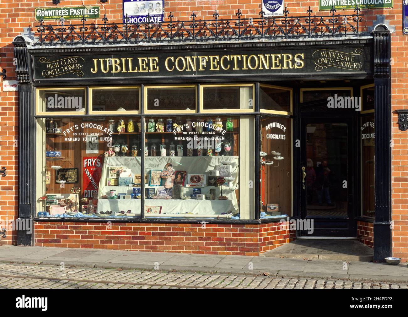 Shop buildings in the wonderful 1900's town at Beamish Museum - confectioners shopfront and window displays. Stock Photo