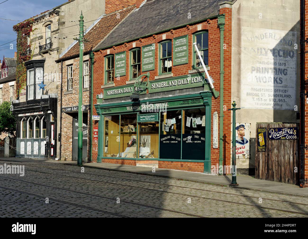 Shop buildings in the wonderful 1900's town at Beamish Museum - newspaper office and pub shop fronts. Stock Photo